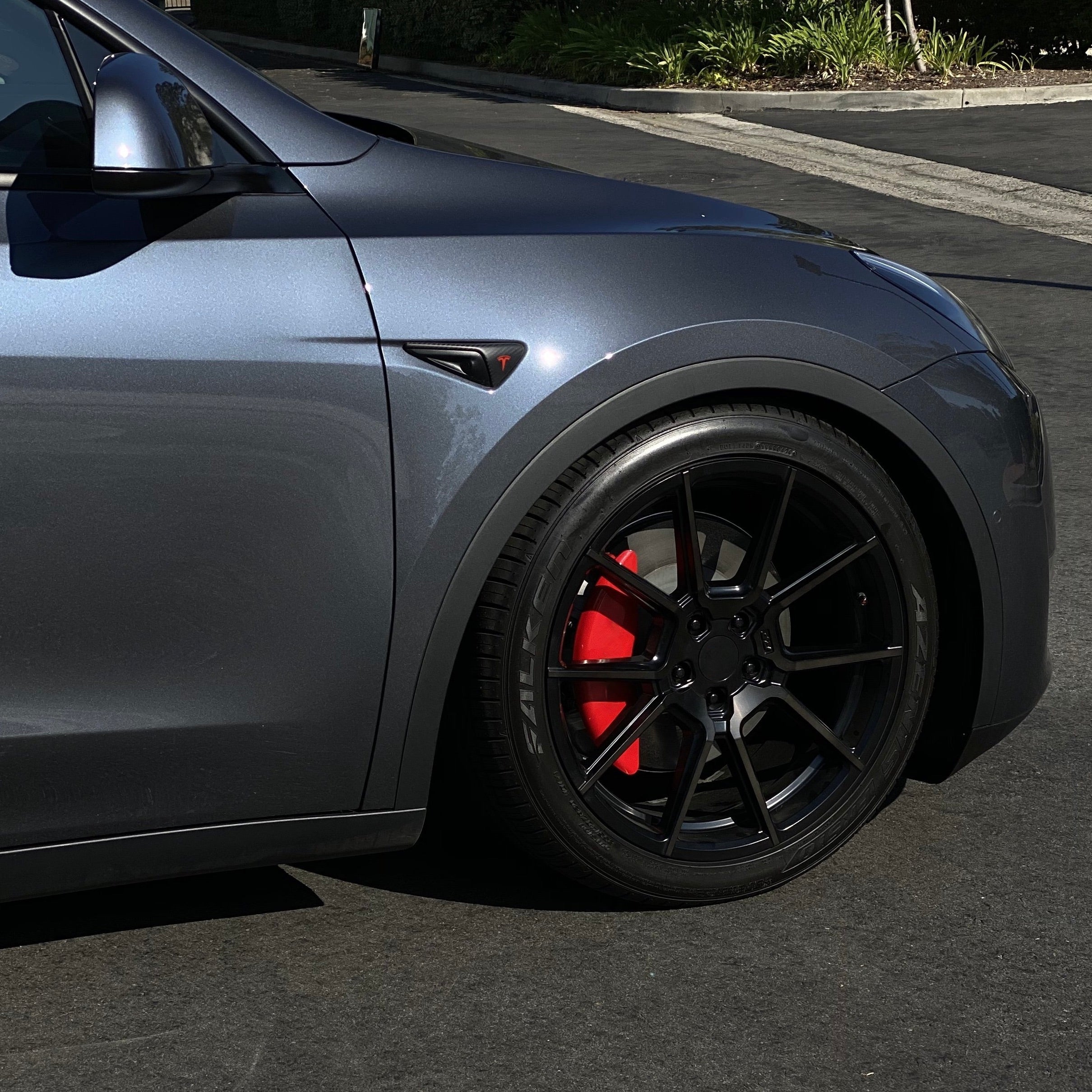 Tesla Model Y With Red calipers and Gloss Black Powder coat wheels