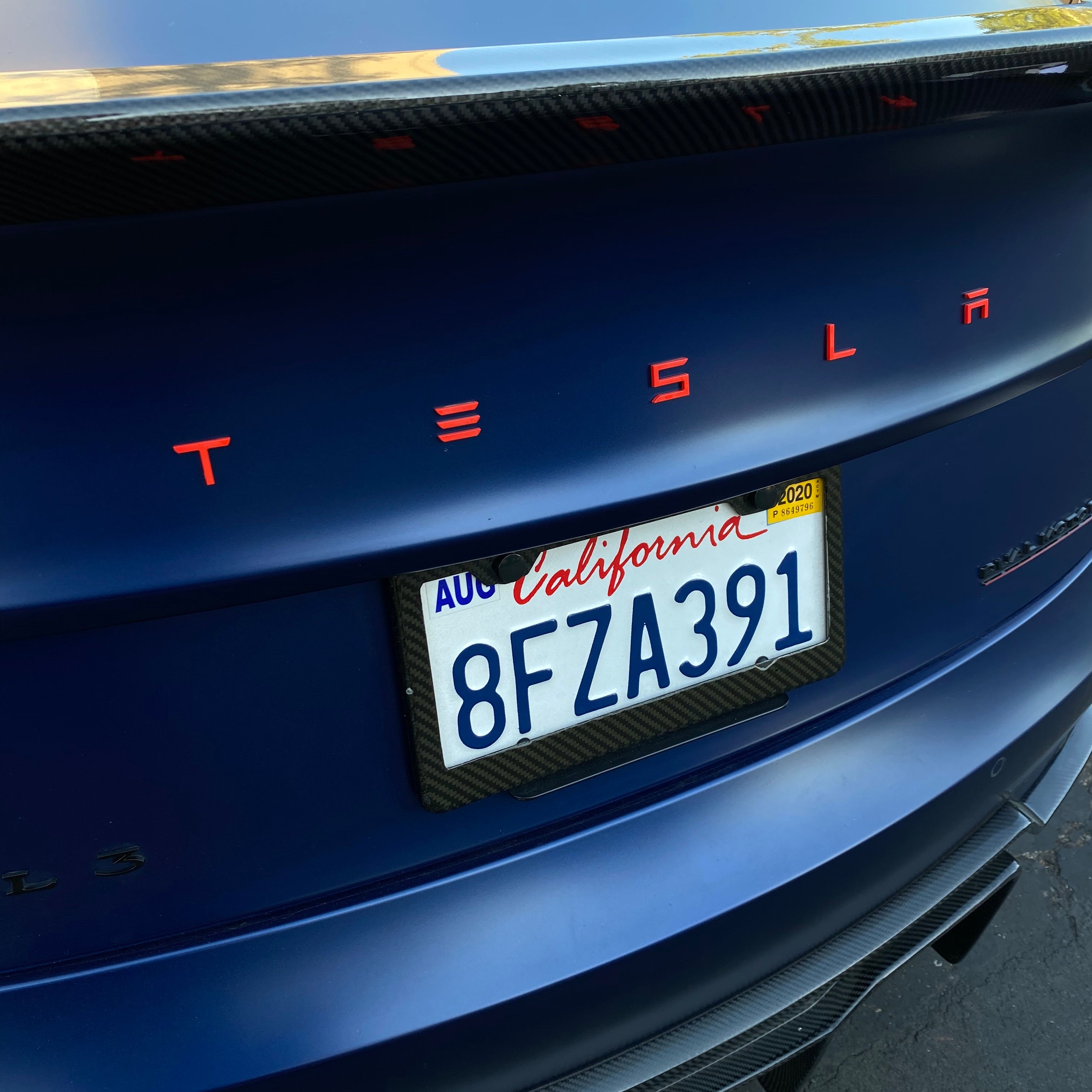 Red tesla emblem model y discount